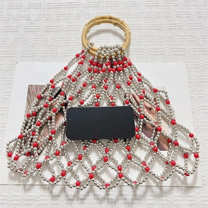 Detail view of woven pearl mesh bag showing large capacity for smartphone storage