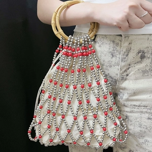 Detail of red and silver beaded mesh handbag with bamboo handles and drawstring liner
