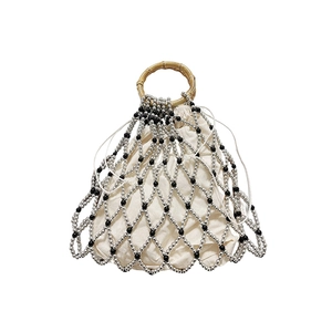 Detailed view of handmade beaded mesh handbag with bamboo handles and drawstring liner