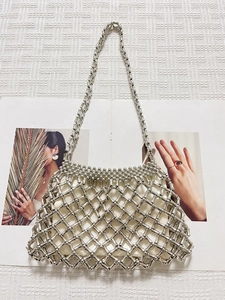 Silver beaded acrylic mesh handbag with woven metallic tubes and white fabric lining