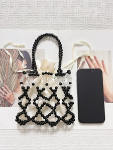 Vertical view of retro beaded handbag with hollow mesh and satin drawstring inner bag