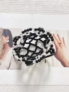 Detailed view of handmade woven beaded bag with high-gloss black and clear crystal beads