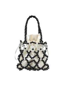 Macro shot of handcrafted black beaded frame bag with a satin drawstring inner pouch