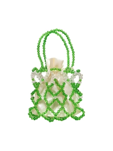 Detail of green and clear beaded handbag showing woven mesh texture and satin inner pouch