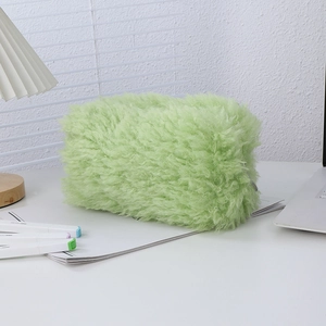 Close-up of the light green faux fur pouch showing soft plush texture and metal zipper