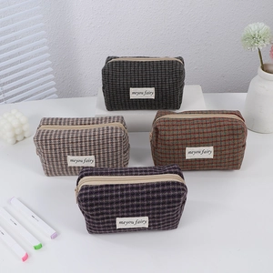 Set of four checkered plaid storage bags in grey, khaki, orange and purple colors