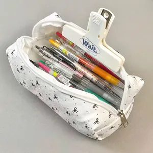 Minimalist white canvas pencil case with black bow patterns and large capacity storage