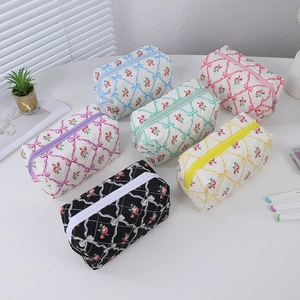 Detailed group view of six quilted pencil cases with vintage rose and bow patterns