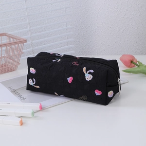 Detail of black pencil case with floral heart texture and cute rabbit embroidery