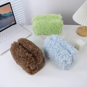 Detailed view of plush teddy fabric stationery bags in green, brown and blue colors