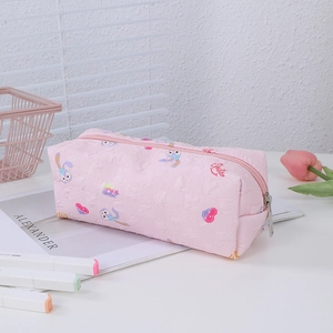 Close-up of pink floral pencil case with cute rabbit pattern and silver metal zipper