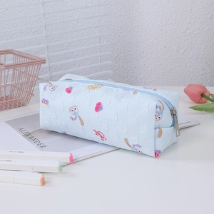Close-up of light blue StellaLou pencil case with embossed texture and floral details