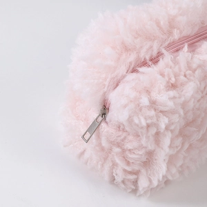 Close-up of pink faux lamb wool pencil case featuring a smooth silver metal zipper detail