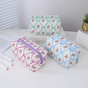Quilted floral pencil cases in purple, blue, and green colors for school stationery storage