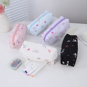 Detail of five pastel pencil cases with cartoon rabbit prints and zip closure