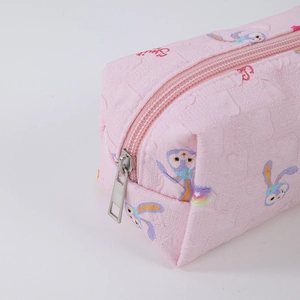 Close-up of pink floral jacquard fabric and metal zipper on StellaLou pencil case