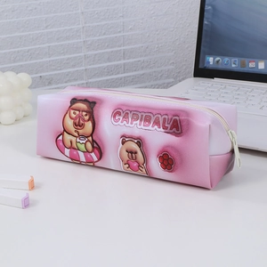 Detailed view of pink Capybara pencil case with cute cartoon print on white desk