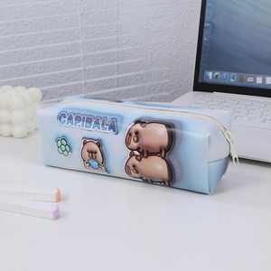 Close-up of sky blue Capybara pencil case on desk with stationery for students