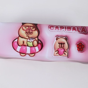 Detail of pink Capybara pencil case showing textured PU material and cartoon prints