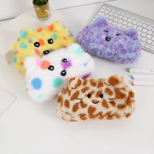Detailed view of plush animal-shaped pencil cases in various patterns on a white desk