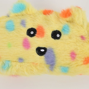 Close-up of cute plush animal pencil case with colorful polka dots and cartoon face