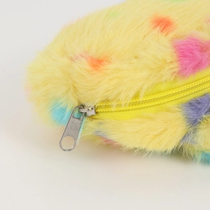 Detail of yellow plush pencil case with colorful polka dots and silver metal zipper