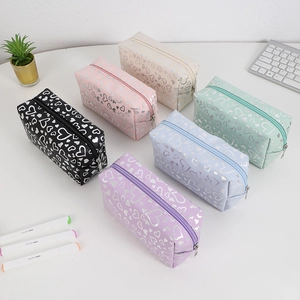 Close-up of heart print pouches in black pink cream green blue and purple colors