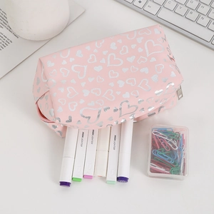 Pink heart print stationery pouch with colorful highlighters on a white desk