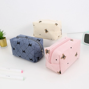 Corduroy cosmetic bags with bow and bear patterns in blue, beige and pink colors