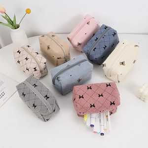 Corduroy makeup bags with quilted patterns and cute bows in various soft colors