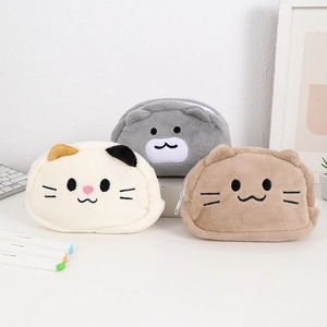 Detailed view of three plush cat and bear pencil cases with cute embroidered animal faces