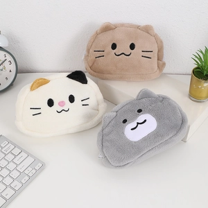 Cute cat plush stationery pouches in brown, beige, and grey colors on a tidy desk