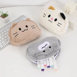 Cute plush cat pencil case in three colors shown with stationery on white desk