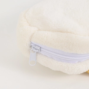 Close-up of smooth white zipper and soft plush texture on cute cat pencil case