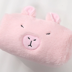 Detailed view of pink plush Capybara pouch with soft faux fur and cute embroidered pig face