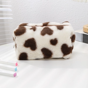 Macro detail of plush heart pattern pencil case with soft texture and sturdy zipper
