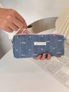 Detail of denim pencil case with star embroidery, pink zipper and pearl pendant