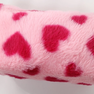 Close-up of soft plush pink fabric with heart patterns on this large makeup bag