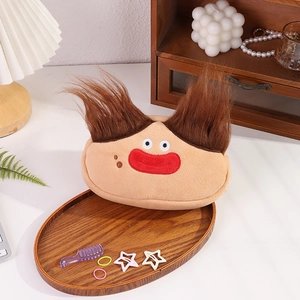 Macro view of plush cartoon pouch with hair accessories and mini comb in a tray