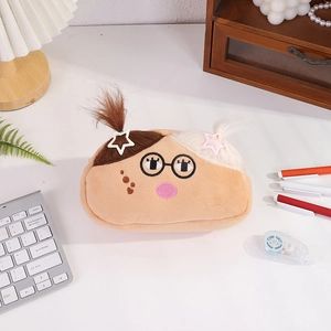 Detailed view of a quirky cartoon plush pencil case on a desk with cute hair clips
