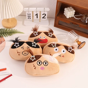 Detailed close-up of four cute plush pencil cases with funny cartoon faces on desk