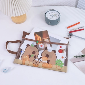 Detail of transparent PVC file bag with cartoon bear print and canvas handle on desk