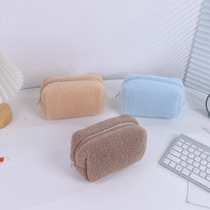 Macro detail of soft cream plush texture on a large capacity minimalist pencil case storage bag