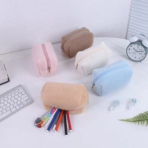 Detail of plush pencil cases in pastel colors with metal zipper and large capacity