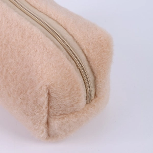 Close-up of soft beige plush pencil case showing luxury faux fur texture and zipper detail