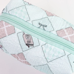 Detail of light green pleated fabric pencil case with bear and bow cartoon prints