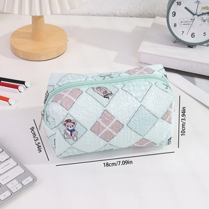 Detail view of a large green quilted pencil case showing the 18x9x10cm dimensions