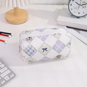 Detail of quilted bear pencil case on a desk with desk accessories in a cozy setting