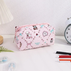 Close-up of pink quilted pencil case with cute sheep and bear patterns and zipper detail