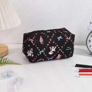 Detail of black quilted fabric pencil case with cute cartoon bear and bunny patterns